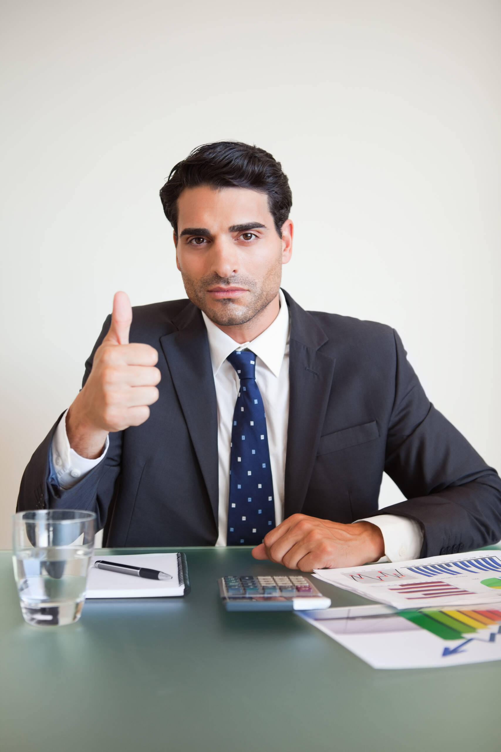 Portrait of a businessman with the thumb up Portrait of a businessman with the thumb up in his office